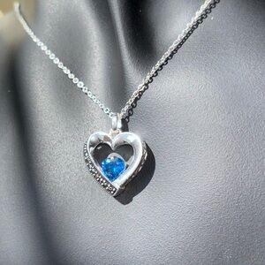 Sterling silver necklace with heart pendant with blue topaz